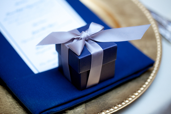 a dark blue box with a silver ribbon on a place setting - wedding photo by top Philadelphia based wedding photographers Langdon Photography